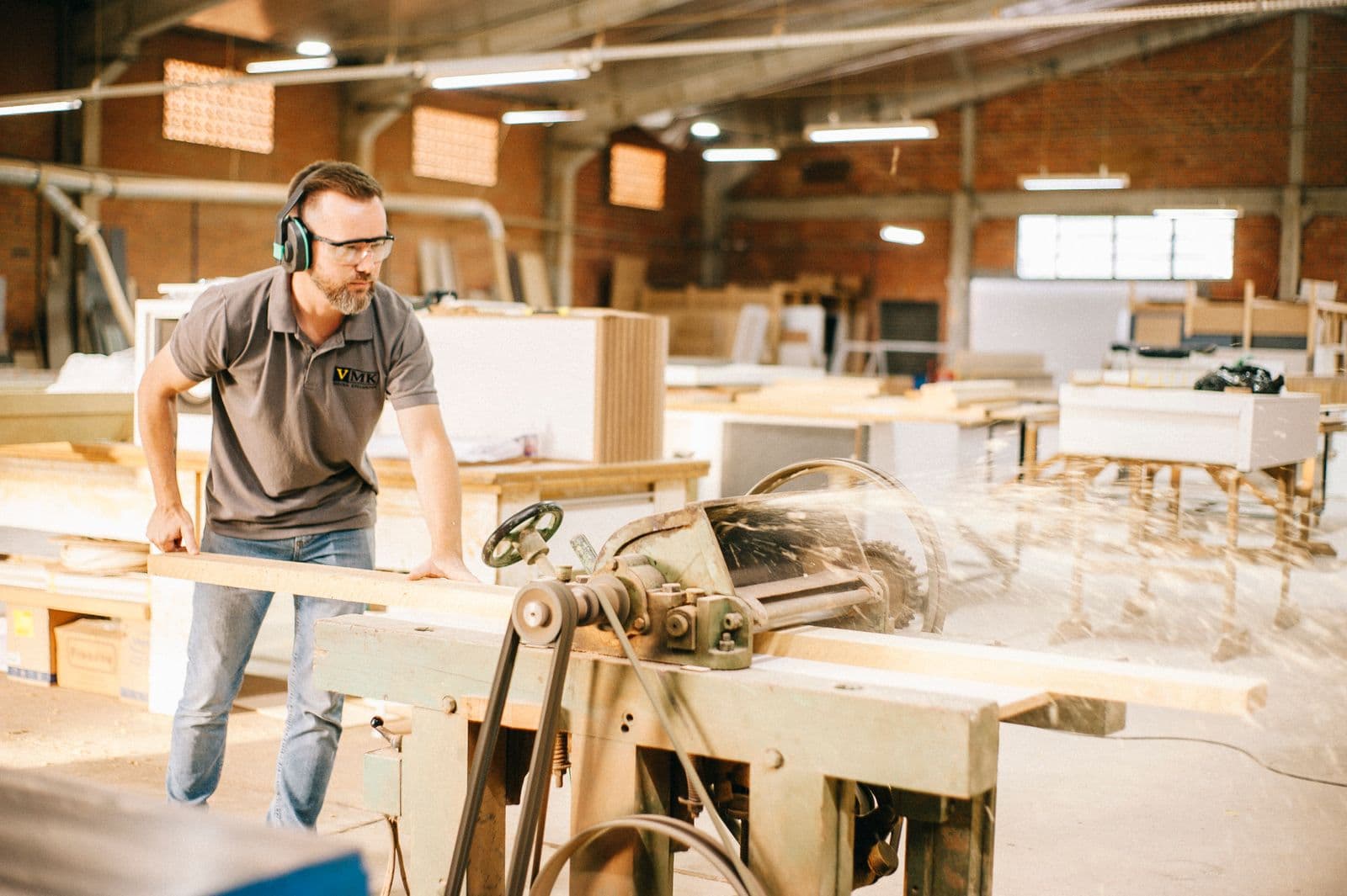 Carpenter working in a busy workshop